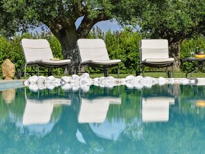 relax under the secular olive trees by the pool 