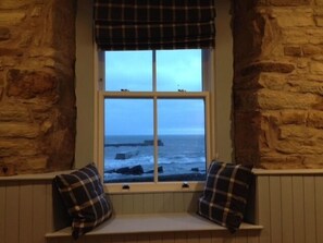 Moody view from the Snug with the waves outside the window.