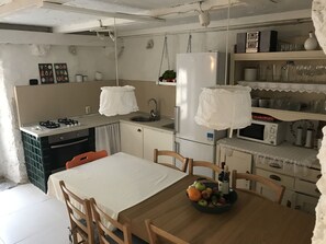 Full equipped kitchen with dining area overlooking the pool