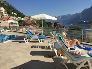 Beds and parasols  by the pool.