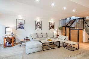 Lounge and stairs leading up to the bedrooms and terrace 