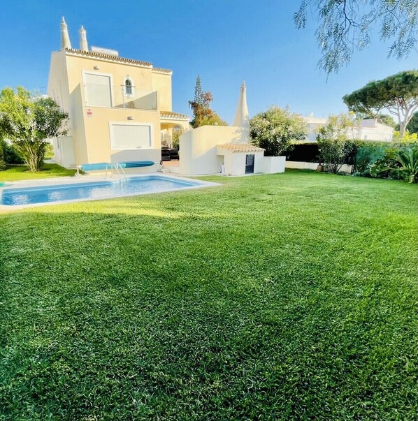 Rear of villa with heated pool, garden and first floor terrace