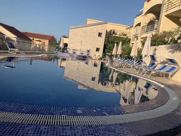 Family pool with sunbeds