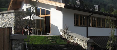 Summer view of apartment and patio area .