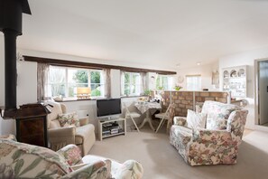 Cosy sitting room with log burner