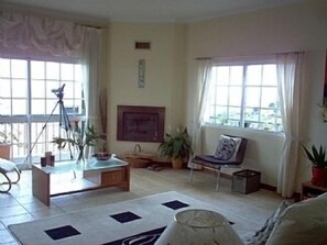 Sunny sitting room with log fire