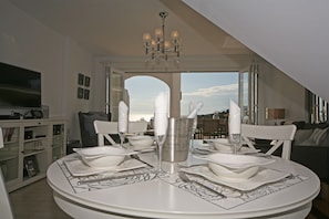 Table table with view through the lounge. Bifolding doors brings that outside in