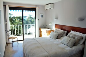 Double bedroom with balcony and view over the communal garden towards the sea