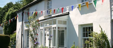 Tremorna cottage at midday, with its elegant 18th century porch.