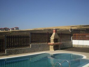 Swimming pool and BBQ overlooking fields to the rear of the property 