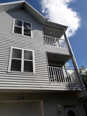 Front of 2 floor town house with large garage.