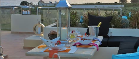 Outdoor dining on the roof terrace overlooking the sea & mountains.