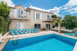 Villa features a large sea side terrace with sun beds around the large pool