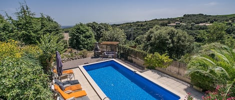 Loungers around the pool - view of vineyards to the coastline
