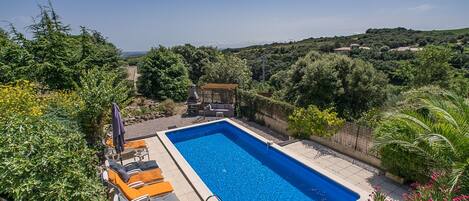 Loungers around the pool - view of vineyards to the coastline
