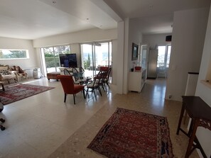 Living room and kitchen are connected yet separate, taken from the entrance door