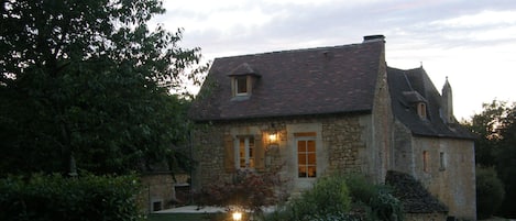 cottage  and garden at dusk