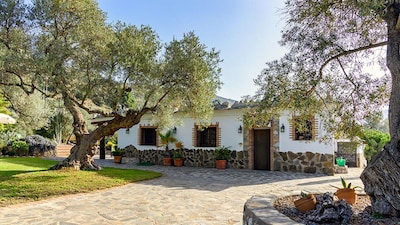 Ein schönes Landhaus in einem schönen Garten mit 360-Grad-Blick auf die Berge.