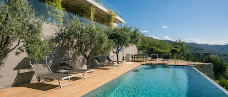 Enjoy lazy days in the sunshine by the infinity pool