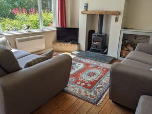 There is a TV and DVD player in the living room 