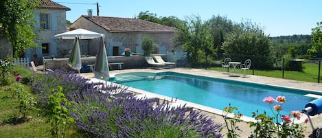View of the farmhouse and converted barn with swimming pool.
