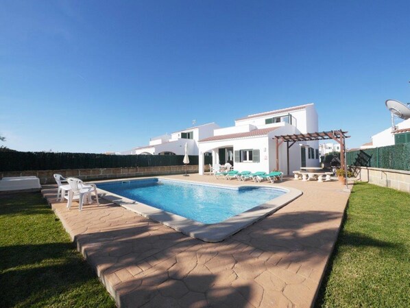 Amazing swimming pool surrounded by sun beds and lounge