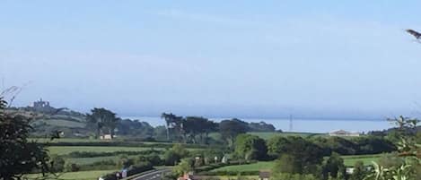 View on a sunny day from the master bedroom across to St Michaels Mount & the se