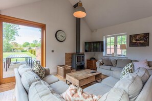 Cottages in the Walled Garden, Fring: Gardener's Cottage sitting room with wood burning stove