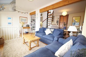 Light, comfortable lounge. Superb river views. Spiral stairs to roof terrace.
