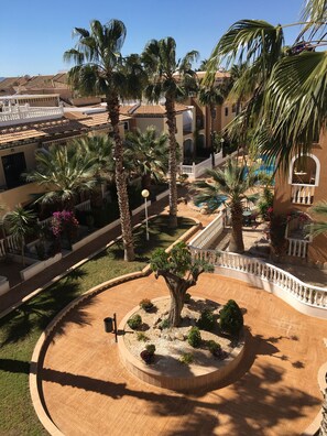 Garden area opposite the apartment terrace leading to the pool.