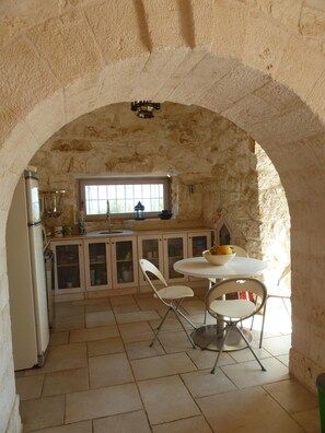 The kitchen and the dining table set-up for four.