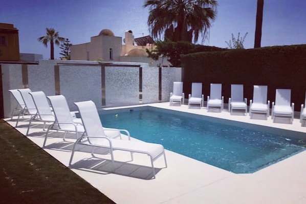 12 loungers surrounding our beautiful private pool with tiled light up back-wall