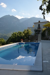 Casa della Zia from the pool with the mountain in the background.