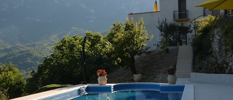 Casa della Zia from the pool with the mountain in the background.