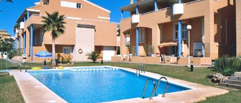 View of apartment overlooking pool (with awning)