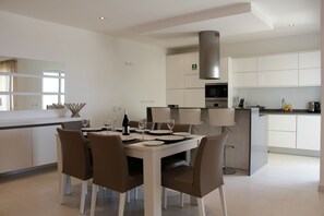Open plan kitchen and dining area with marble breakfast bar