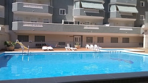 Communal pool with sunbeds