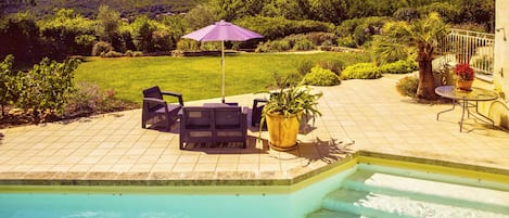 The pool, sun terrace and views of the hills
