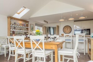 The Potting Shed, Ringstead: Dining area with bi-fold doors to the garden