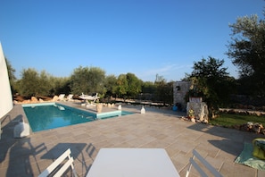 Eat by the pool on the bistro table with umbrella nearby for shade