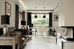 Sunny open plan sitting / dining area with wood burning stove