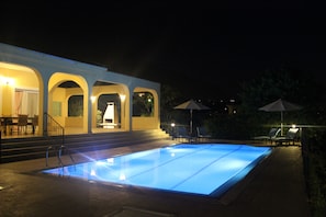 view with pool and patio lights on