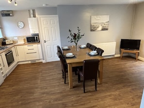 Open plan kitchen/diner leading to the rear patio with hot tub