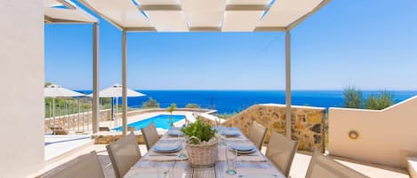 Outdoor dining area with panoramic sea view!