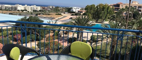 View from the balcony to the sea and pool
