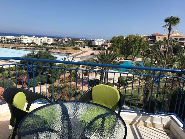 View from the balcony to the sea and pool
