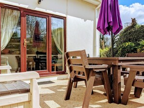 Back of cottage with French doors onto patio.