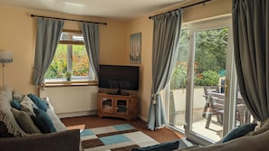 Sitting room with French doors on to enclosed patio.