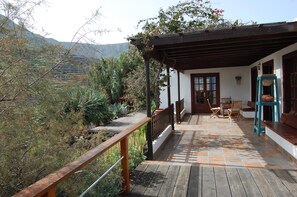 Veranda in front of the house with view over the landscaped garden.