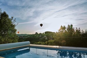 Balloons in flight floating  past the pool